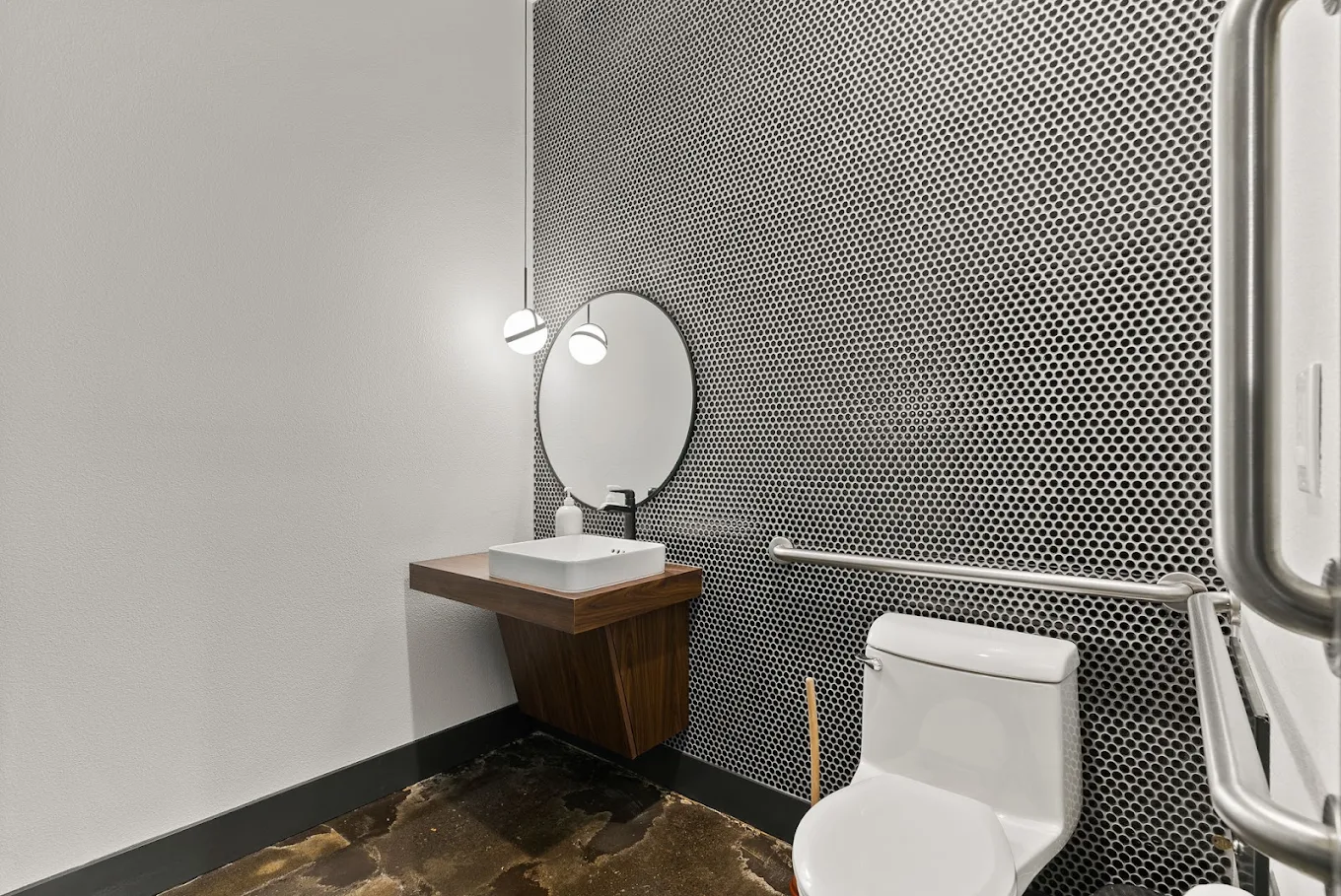 ADA-accessible restroom with grab bars and modern sink
