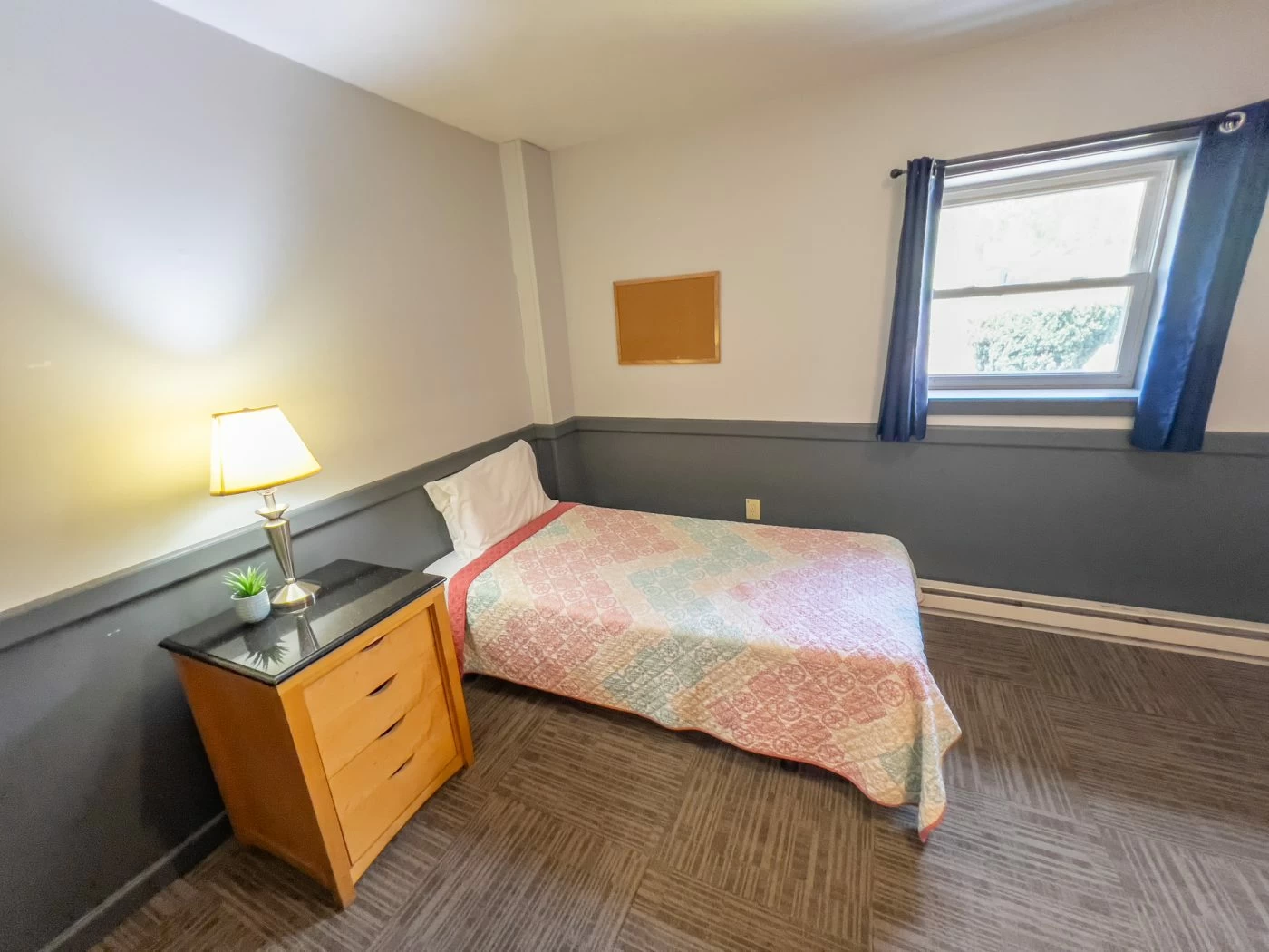 Simple bedroom with twin bed and nightstand