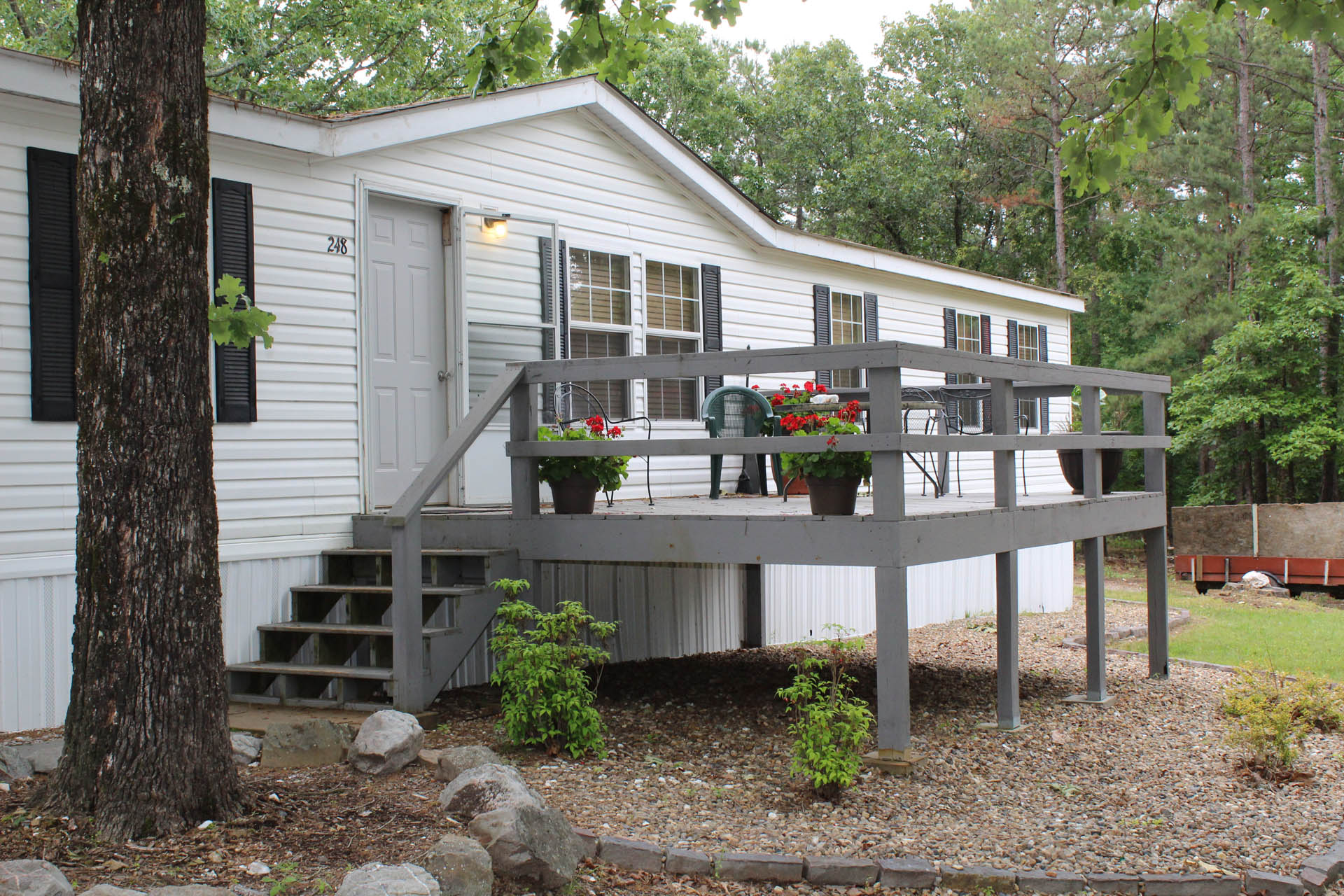 Outdoor seating deck and green space on wooded campus