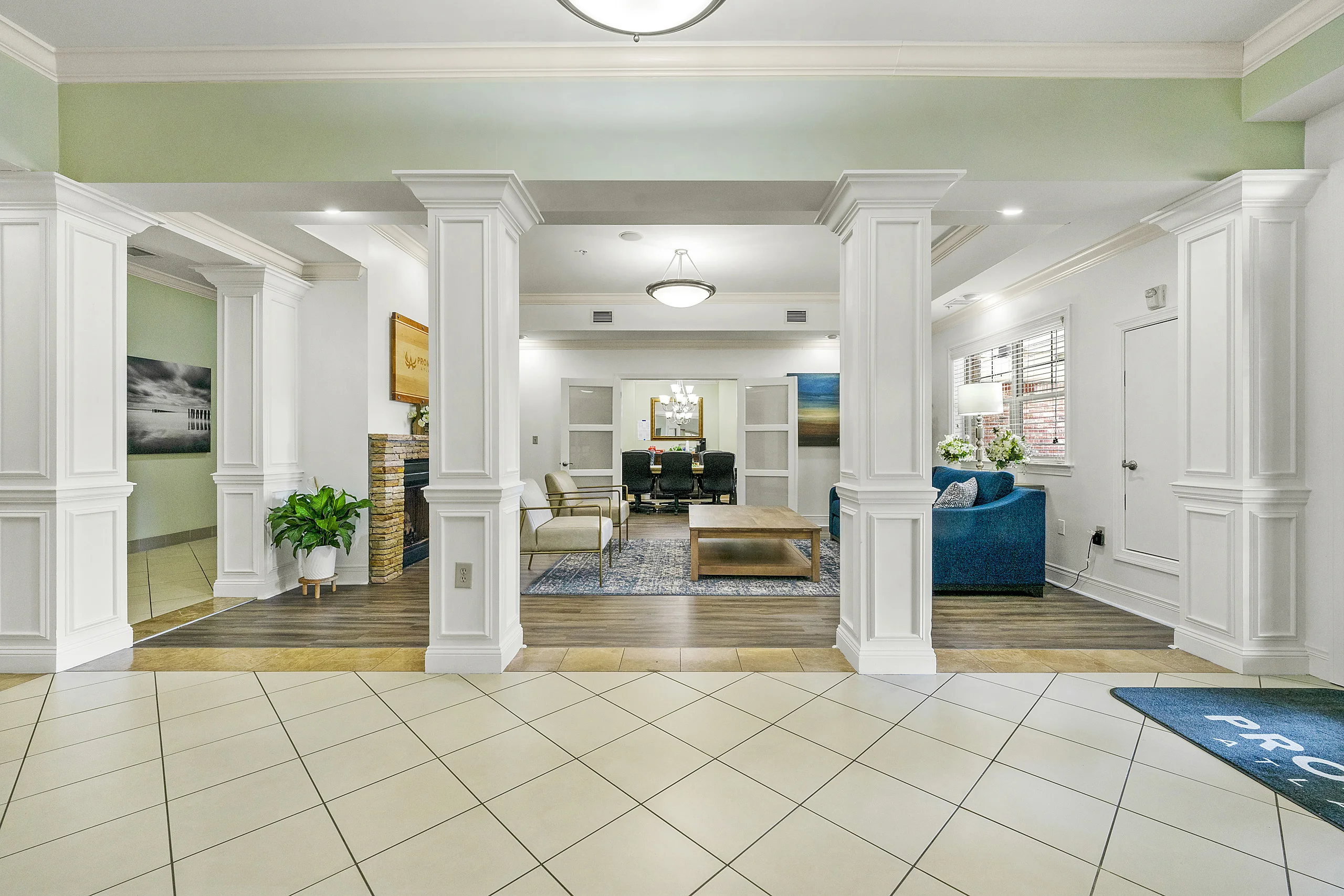 Comfortable reception lounge with fireplace, seating area, and adjacent meeting space