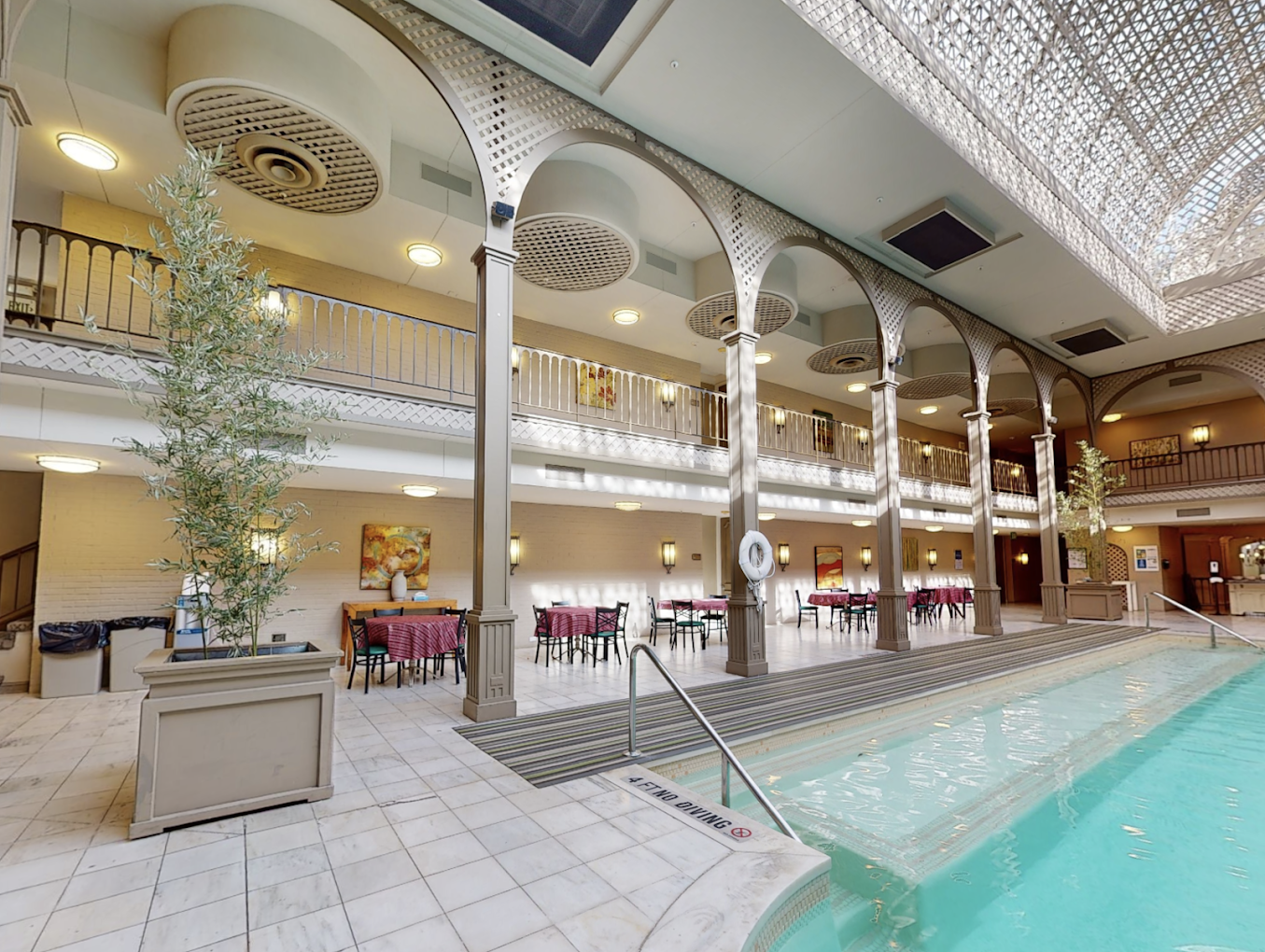 Indoor rehab facility with a pool and dining area.