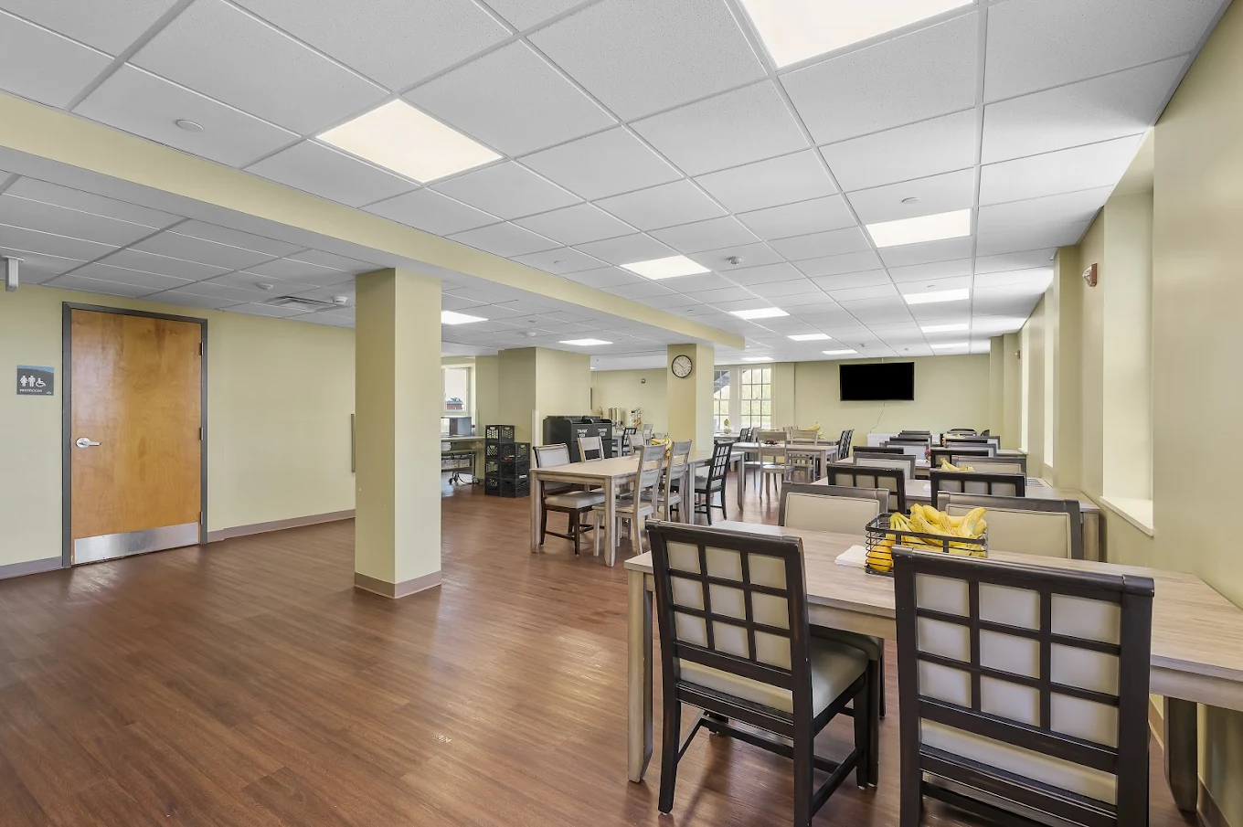 Spacious dining area with multiple tables and chairs at Banyan Delaware’s Milford facility
