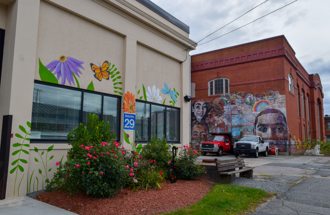 Exterior of Rhodes to Recovery building with colorful mural and gardens