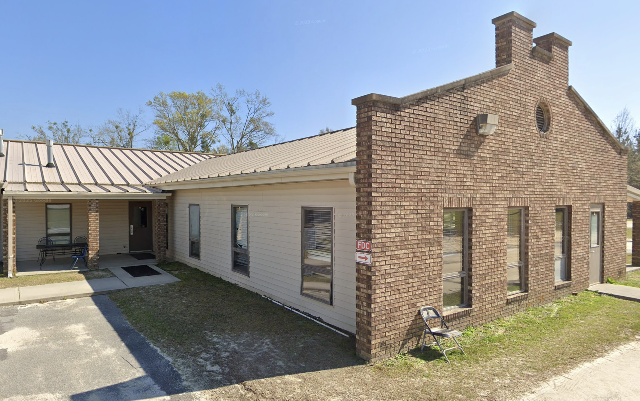Single-story brick and siding building with a metal roof
