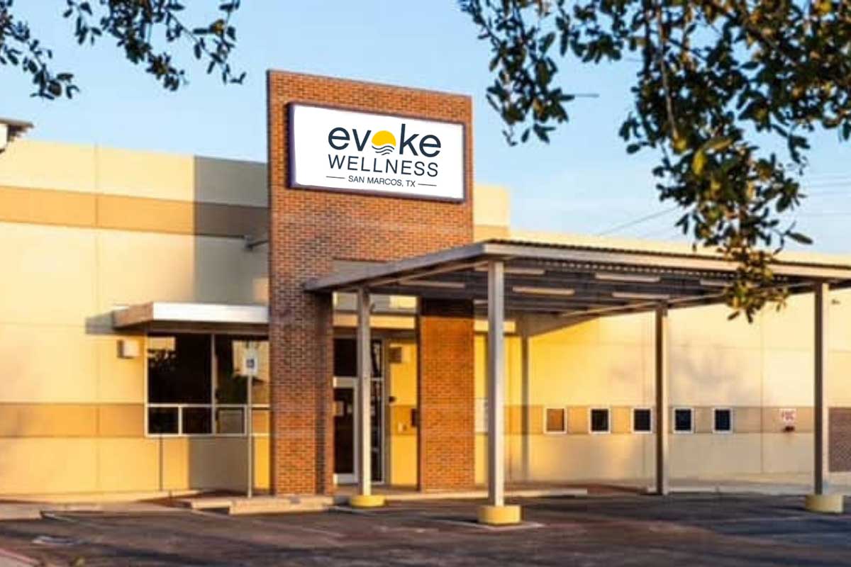 Exterior view of the Evoke Wellness building with signage and covered entrance in San Marcos, TX