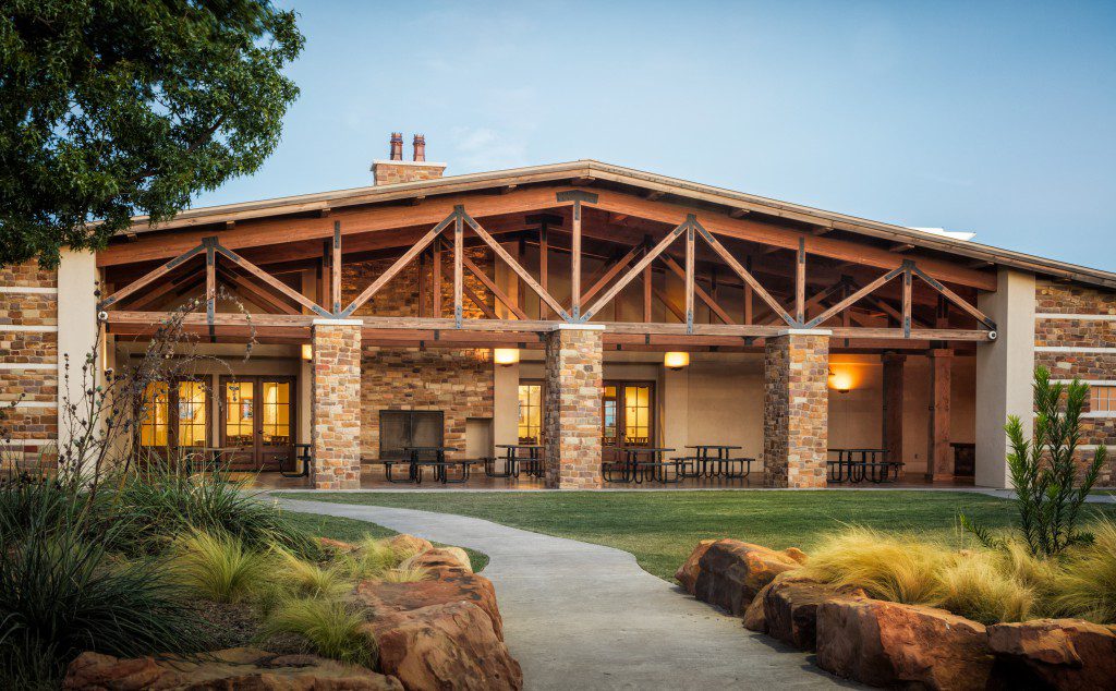 Main lodge with covered patio and landscaped walkway