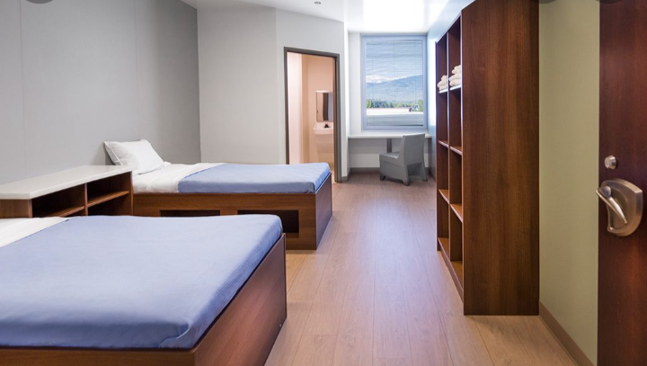 Shared patient room with two beds and window seating