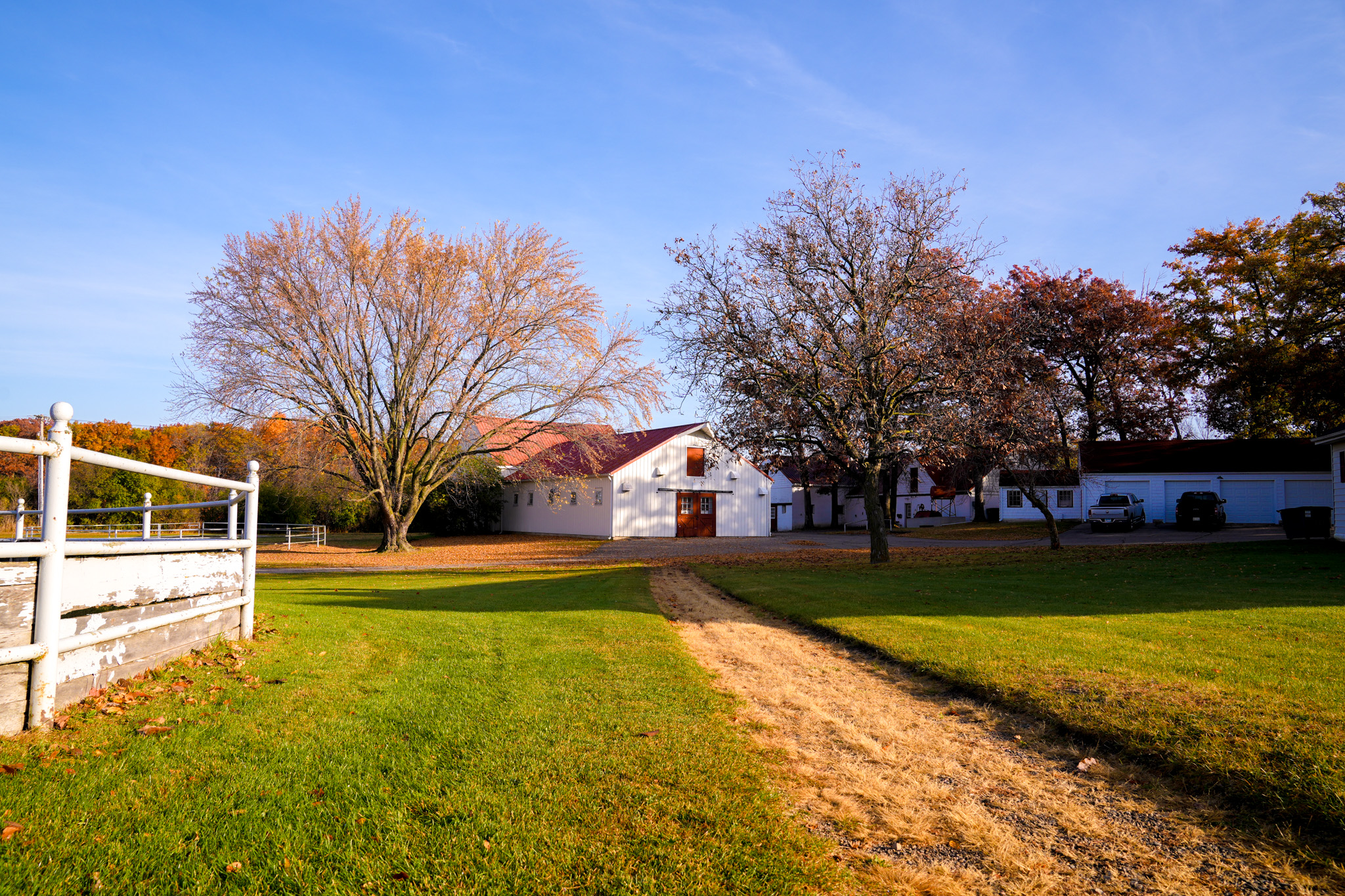 Outbuildings and open lawn with walking path on campus.