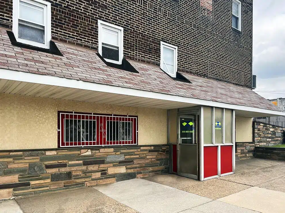 Exterior entrance with barred windows and covered walkway