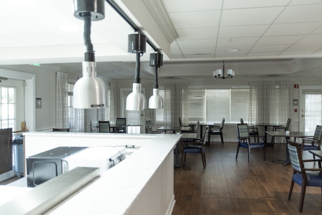 Dining room with tables, chairs, and natural lighting