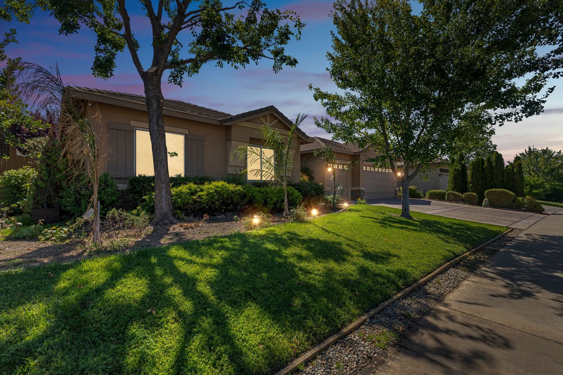 Single-story ranch house with trees and front lawn