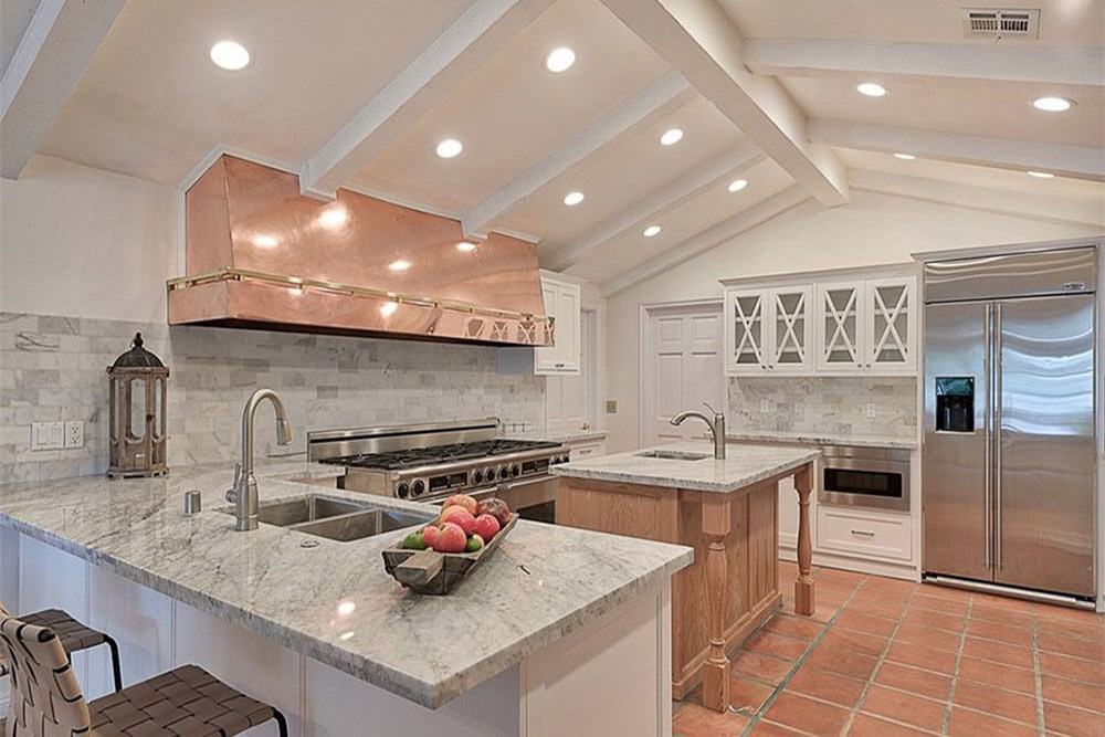 Kitchen with a central island and seating.