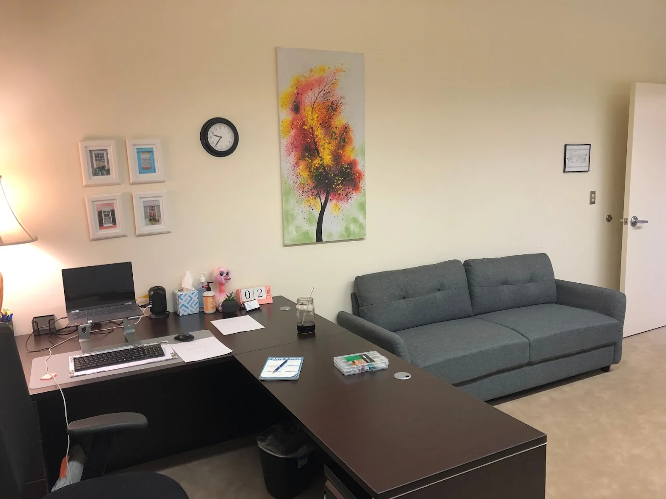 Office with desk, chair, and gray couch