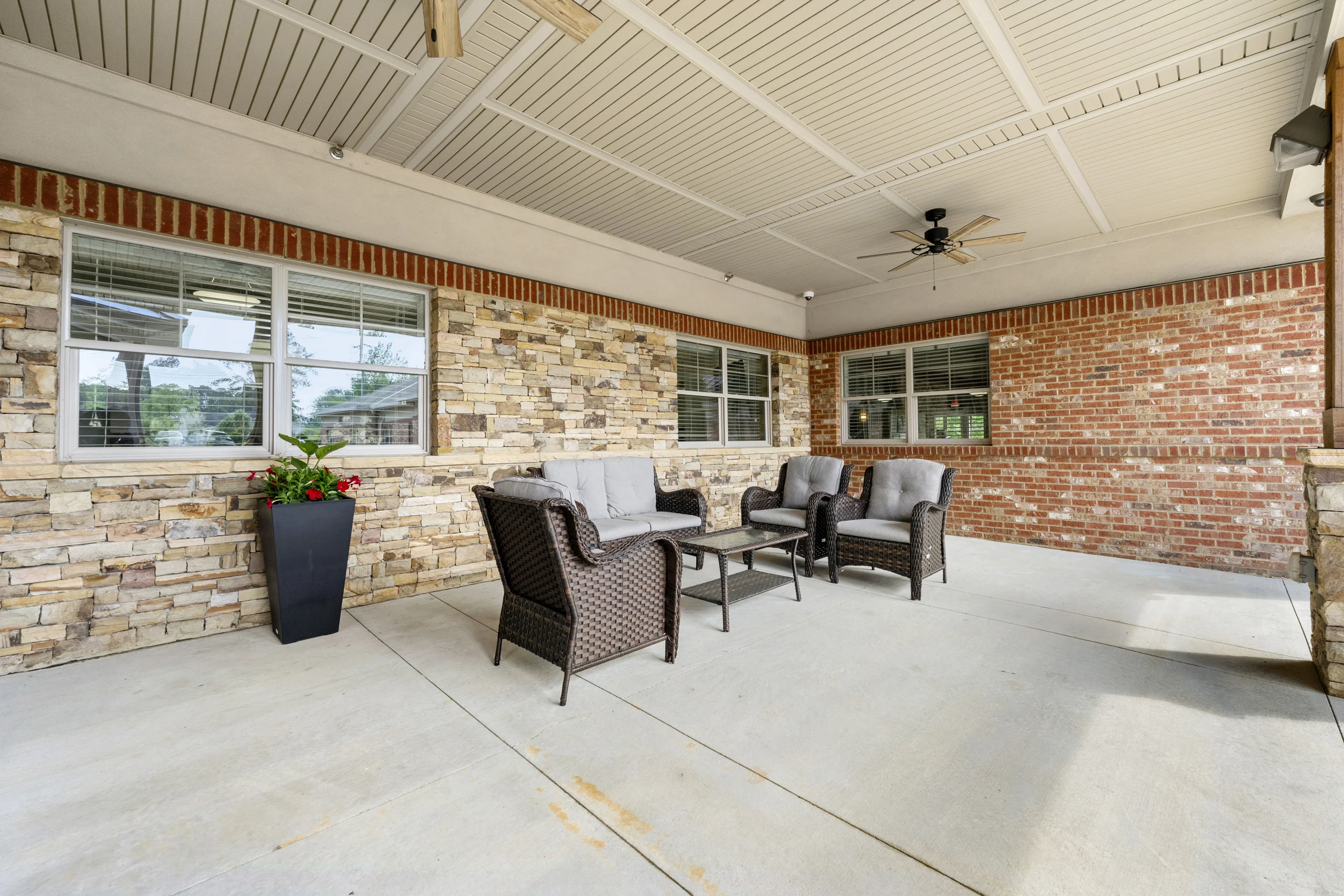 Covered outdoor patio with comfortable seating for relaxation and fresh air at Promises Atlanta