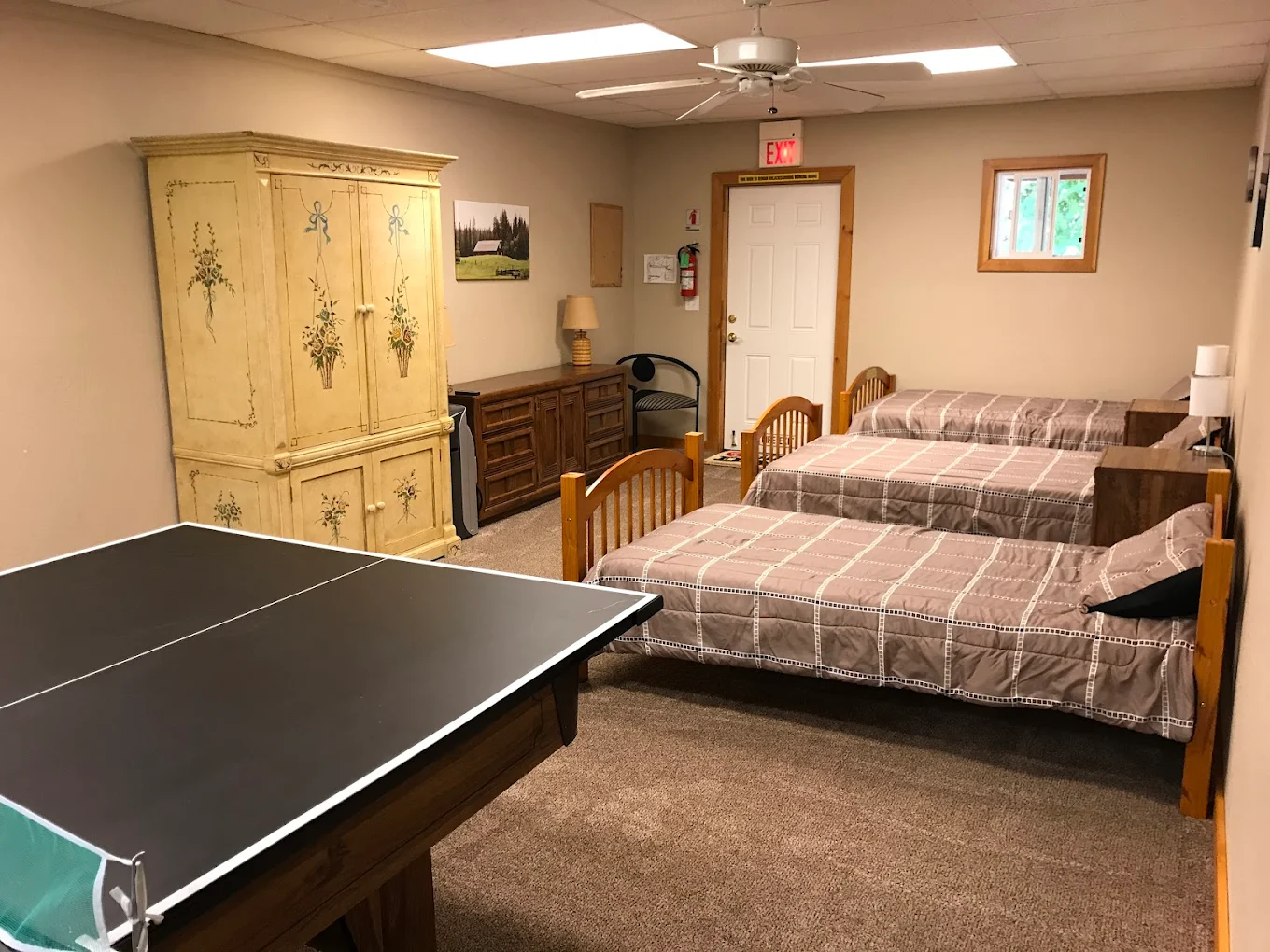 Shared bedroom with twin beds and ping pong table