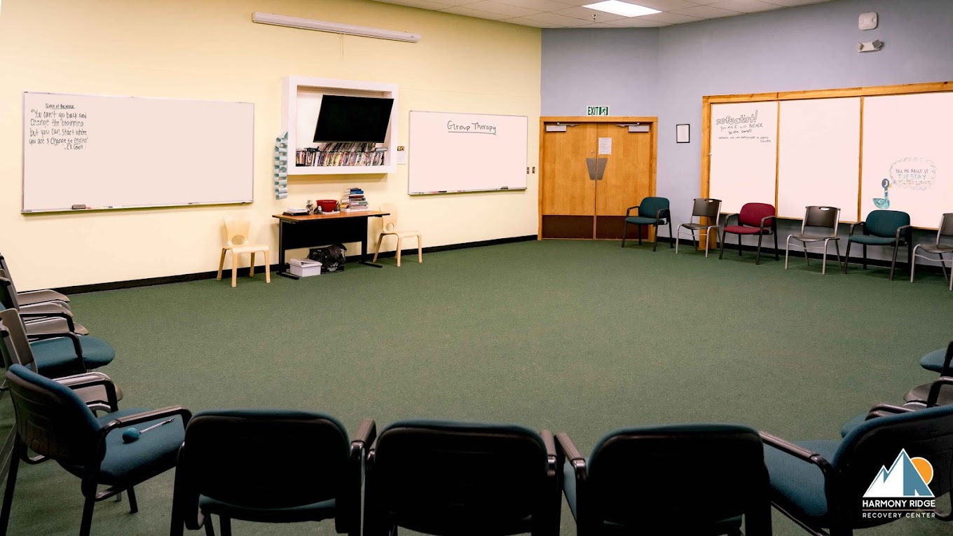A spacious group therapy room with chairs arranged in a circle