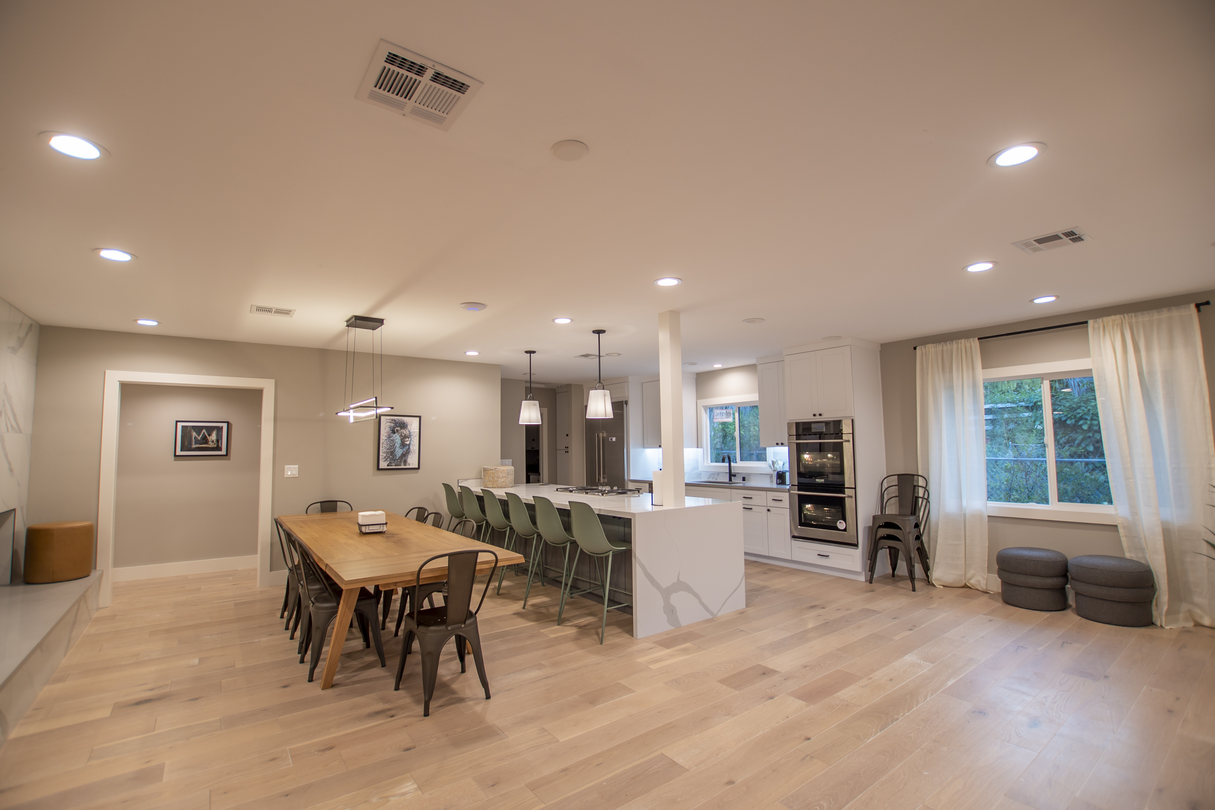 Lounge with leather couches and view of fenced-in pool