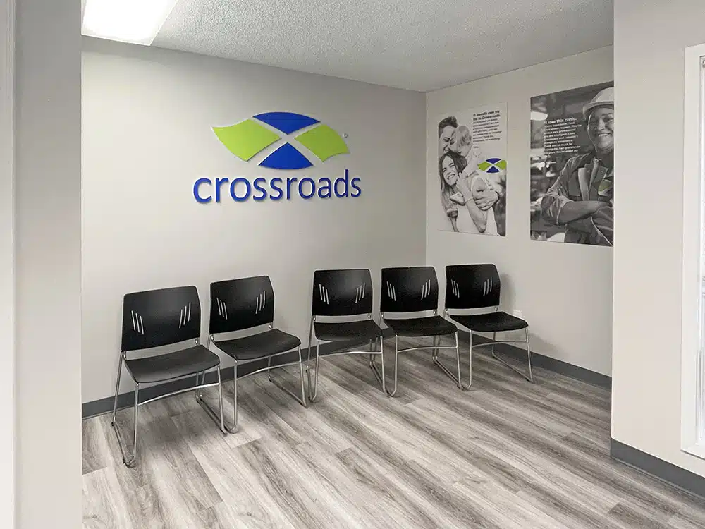Lobby chairs against wall with Crossroads logo signage