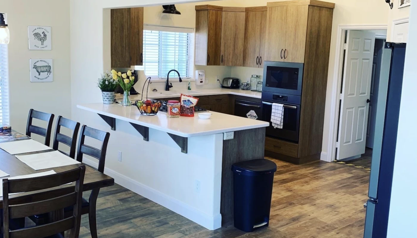 Open kitchen with wood cabinets and island bar