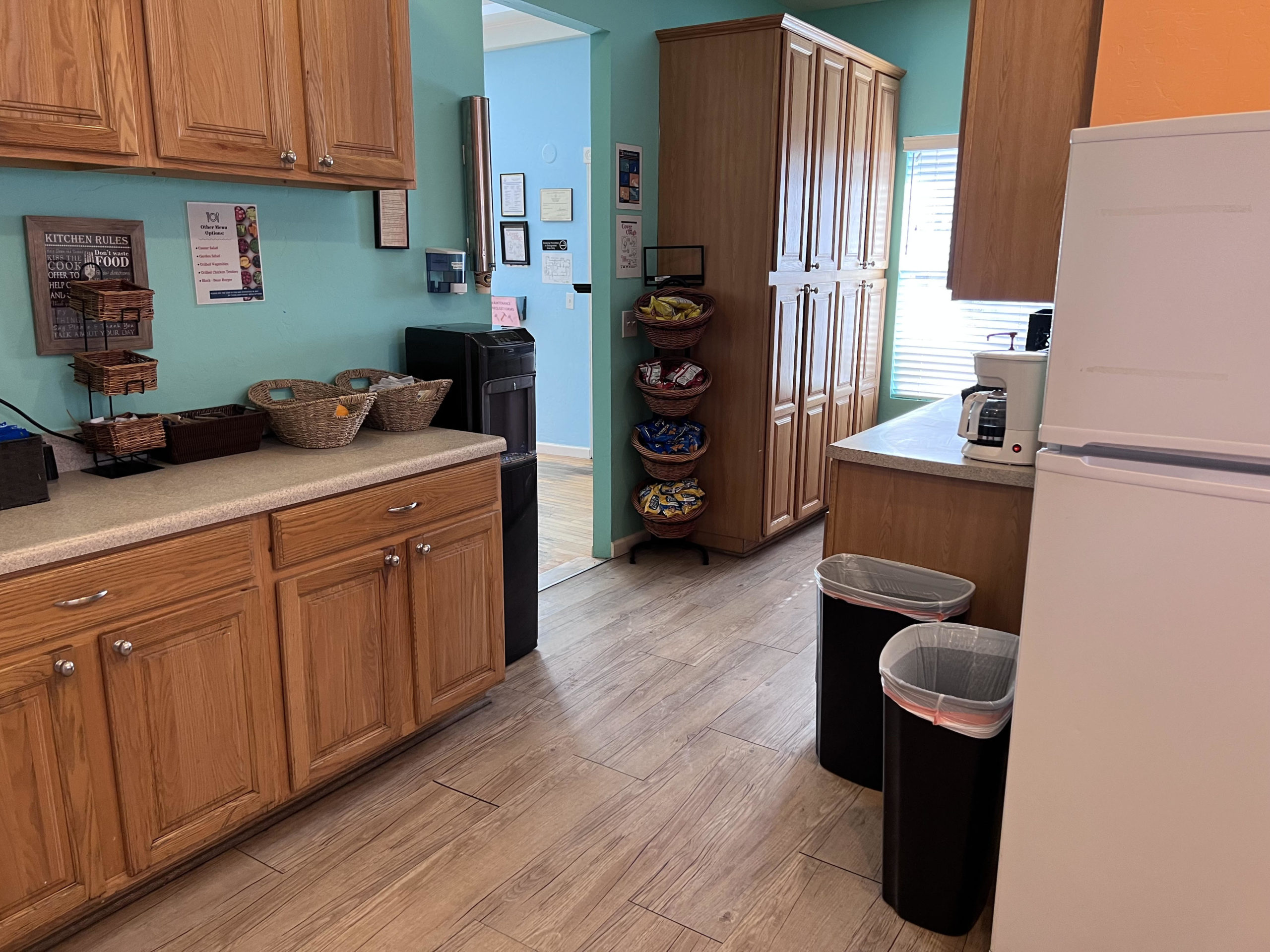 Snack baskets, drinks, and coffee maker in pantry