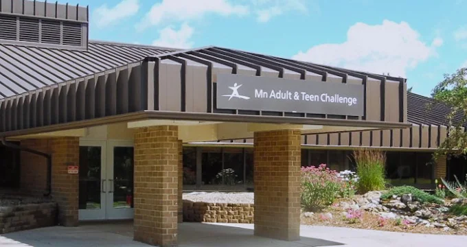 Facility entrance with brown awning and landscaped walkway