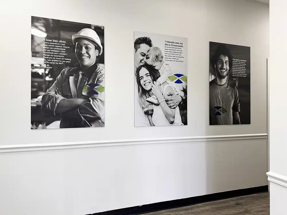 Wall with black-and-white posters of patient stories