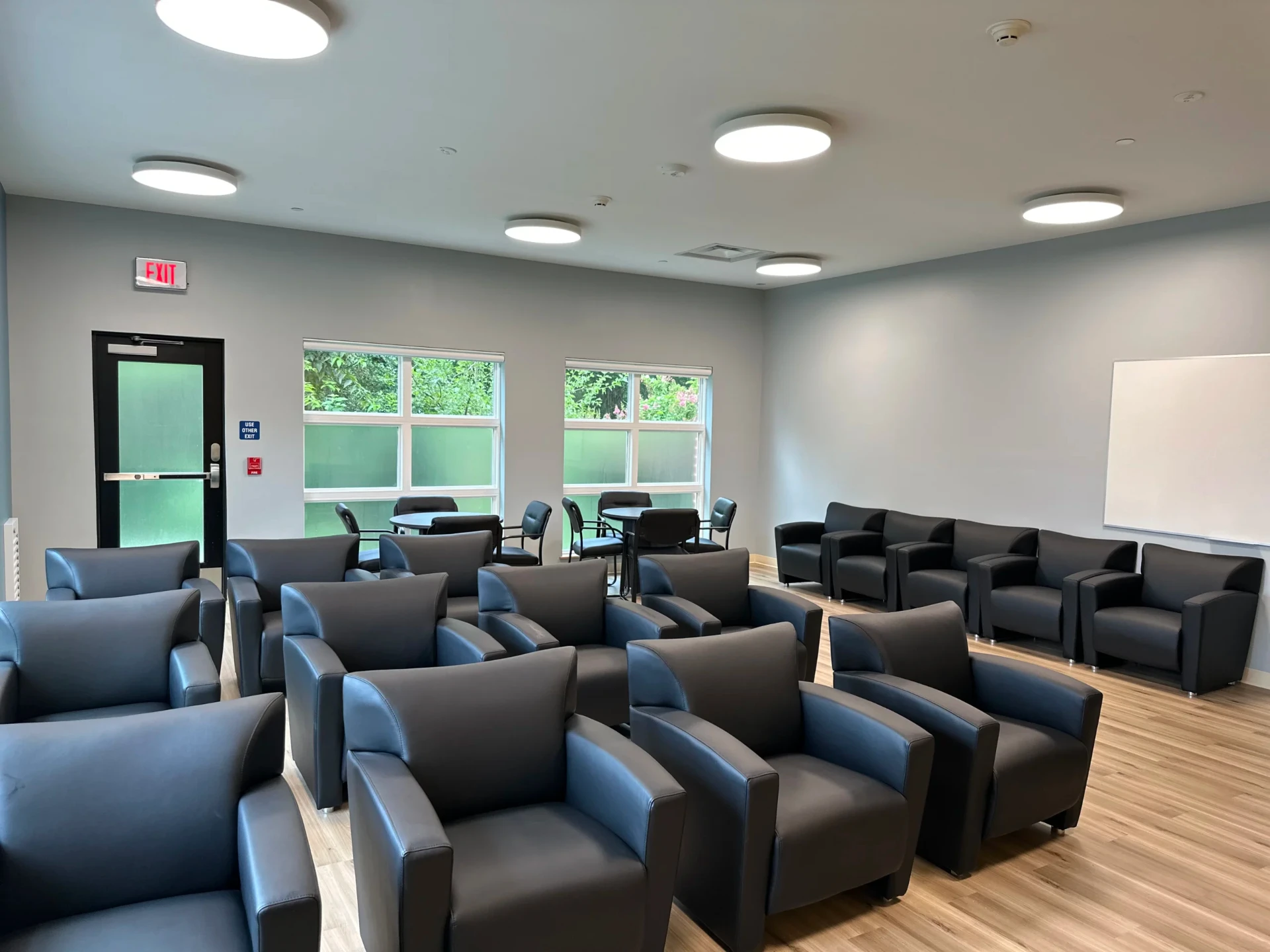 Community lounge with armchairs and group seating.