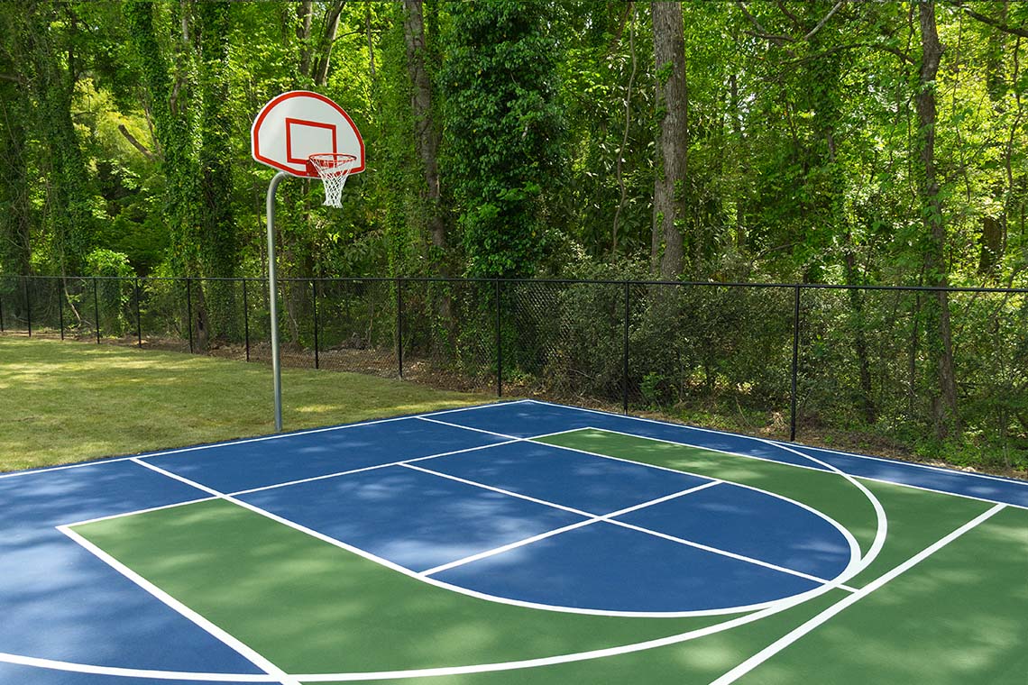 Outdoor basketball court surrounded by trees