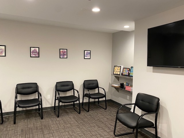 Spacious group therapy room with chairs set in a circle.