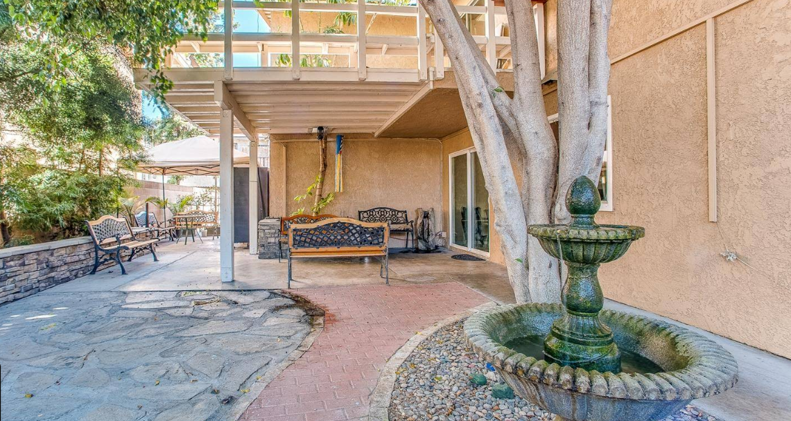 Patio with benches and a stone water fountain