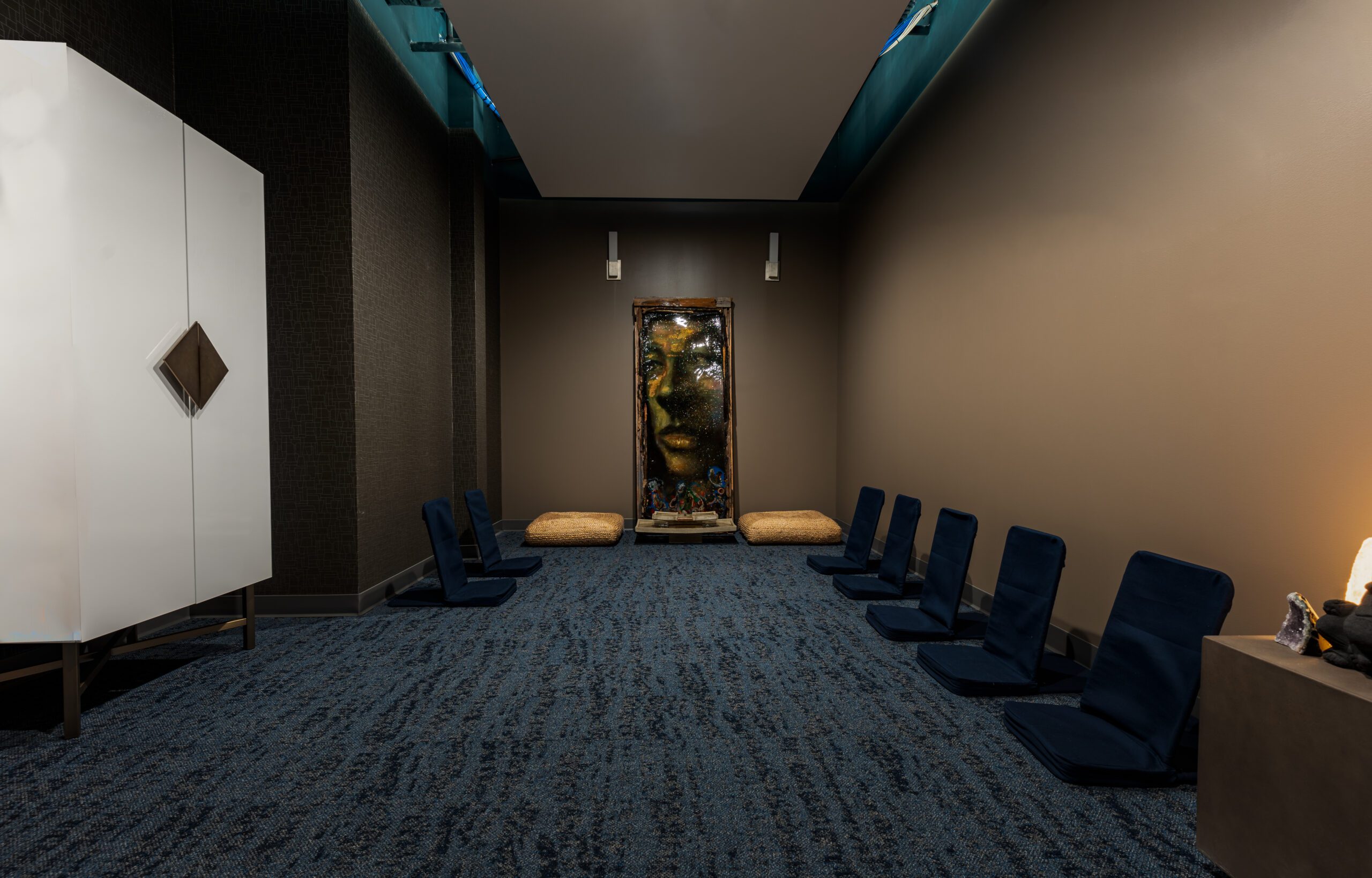 Meditation room with floor cushions and calming artwork