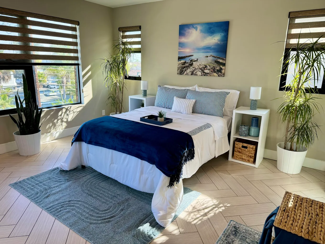 Bright bedroom with queen bed and large windows