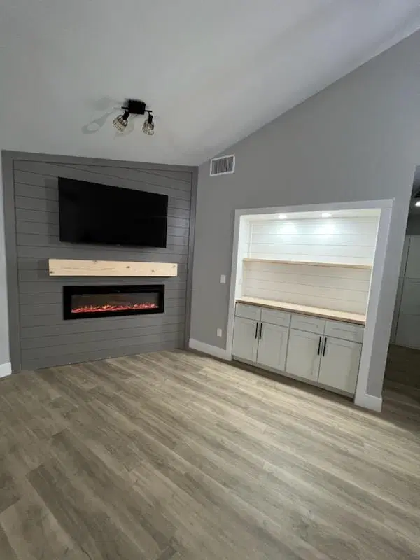 Living room with wall-mounted TV and modern fireplace