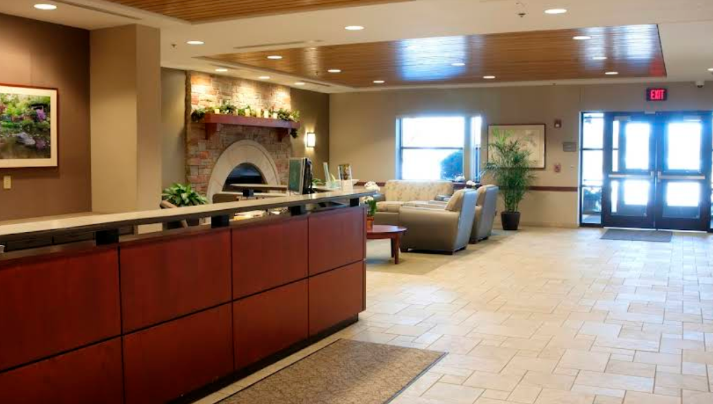 Reception desk with seating and fireplace lounge
