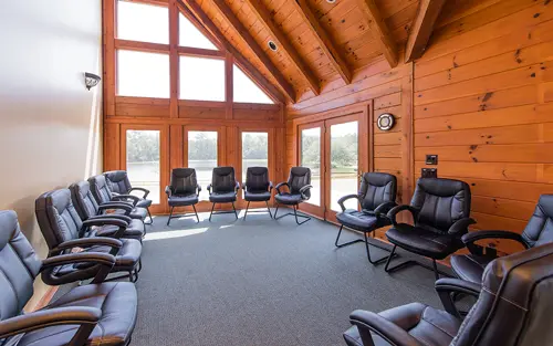 Group therapy room with chairs and large windows