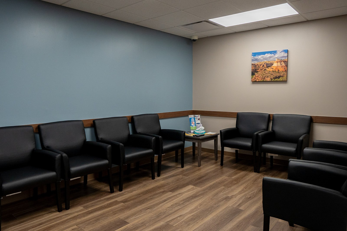 Dosing room with black chairs and small side table