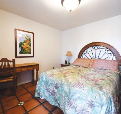 Cozy private bedroom with floral bedding and desk