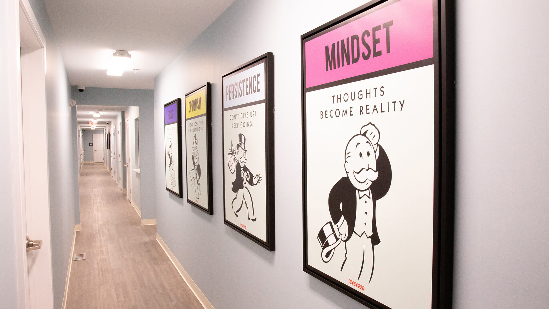 Hallway with doors and art.