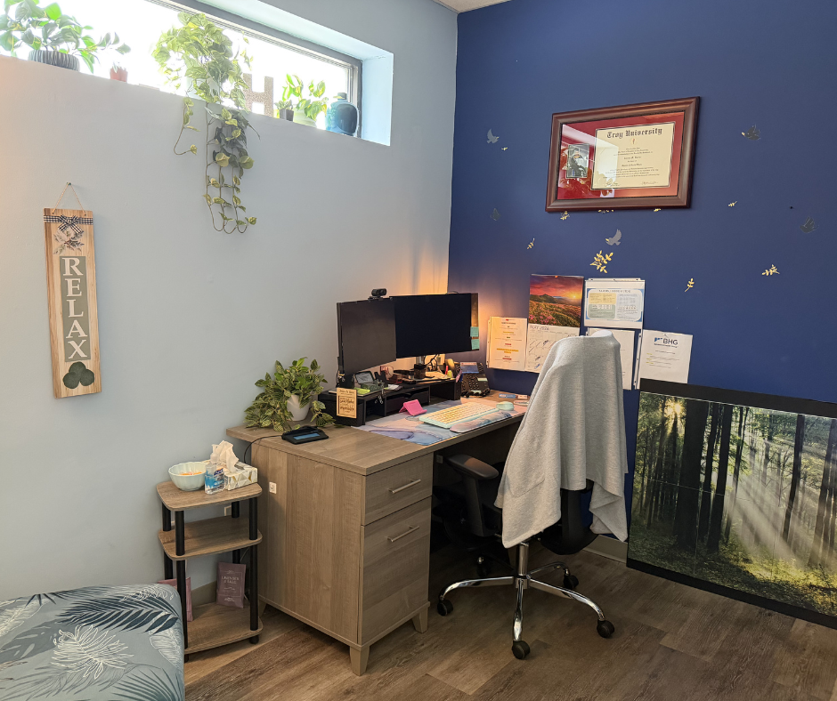 Counseling office with desk, plants, and natural light