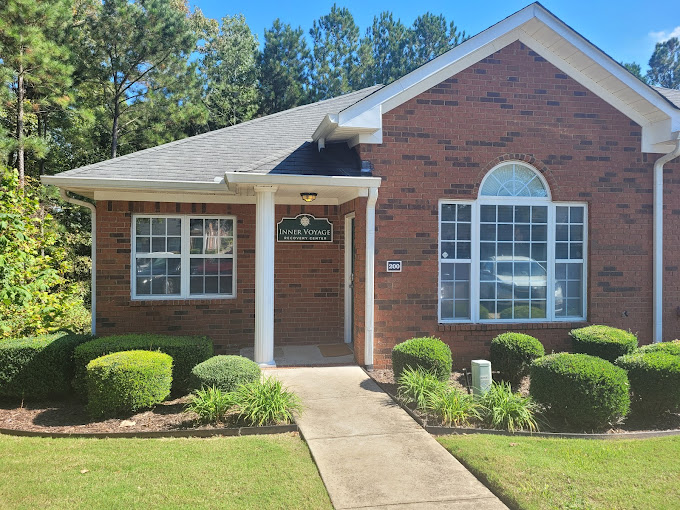 The exterior of Inner Voyage Recovery Center, a brick building with greenery.