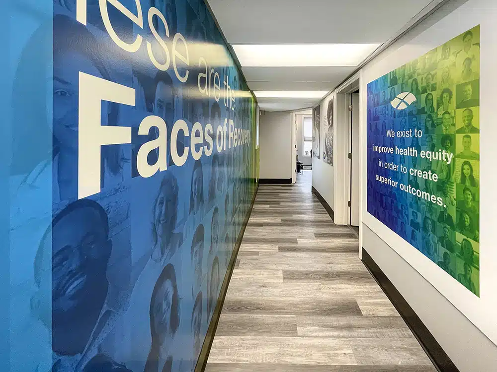 Hallway with large Faces of Recovery mural on wall