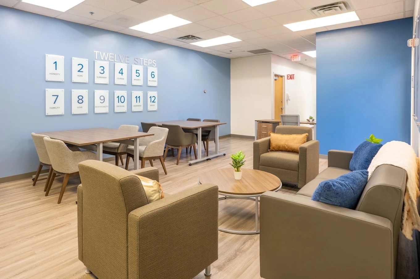 Lounge and dining area with Twelve Steps displayed on wall