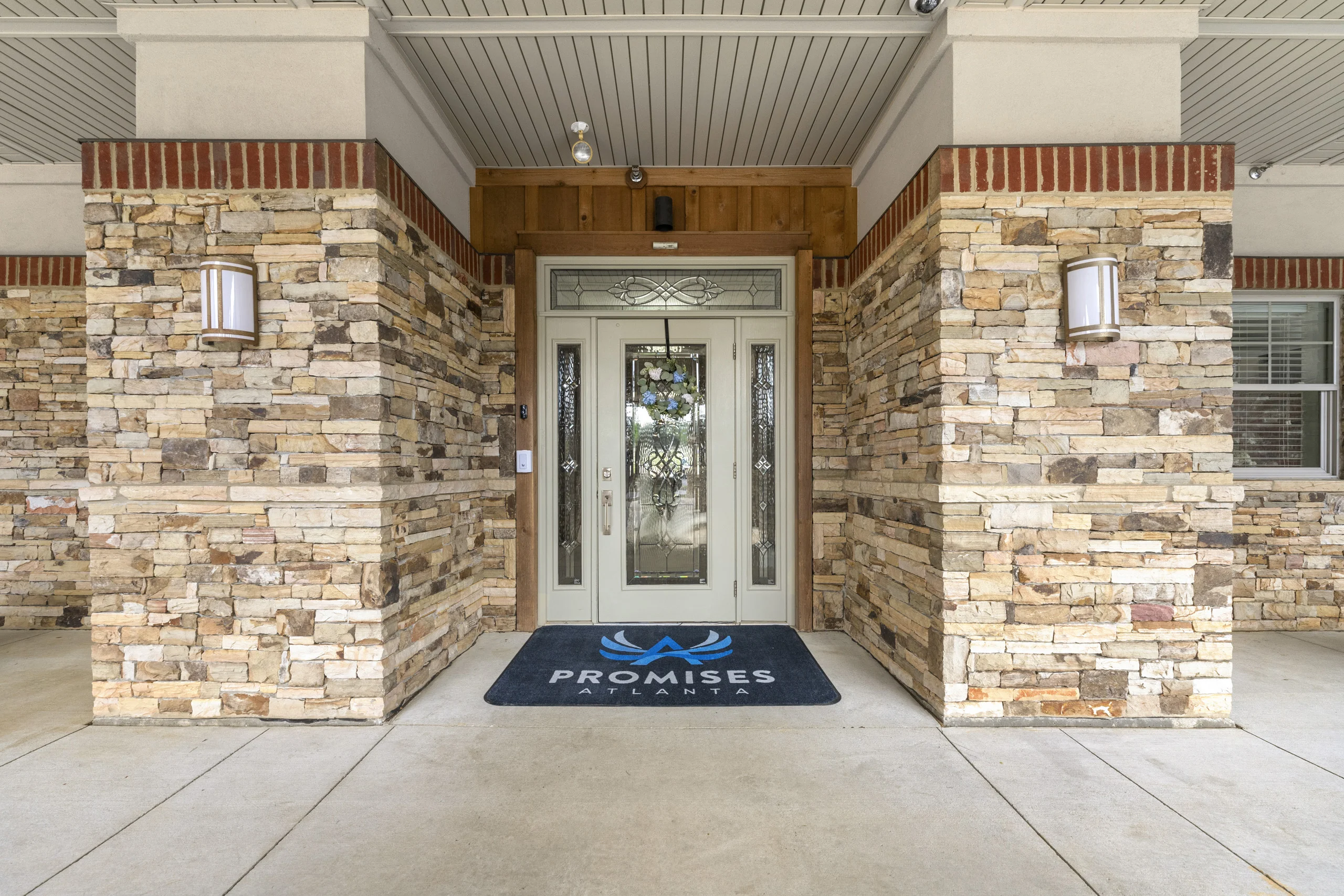 Covered outdoor patio with comfortable seating for relaxation and fresh air at Promises Atlanta