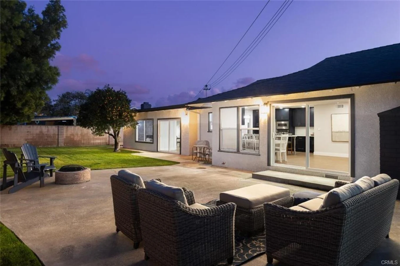 Patio with outdoor chairs and fire pit at dusk