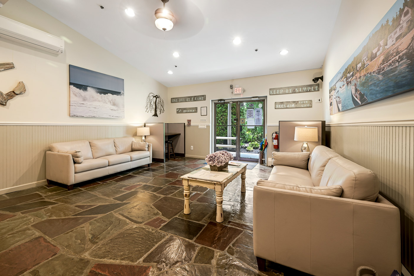 Seating area with coastal décor and wooden accent wall