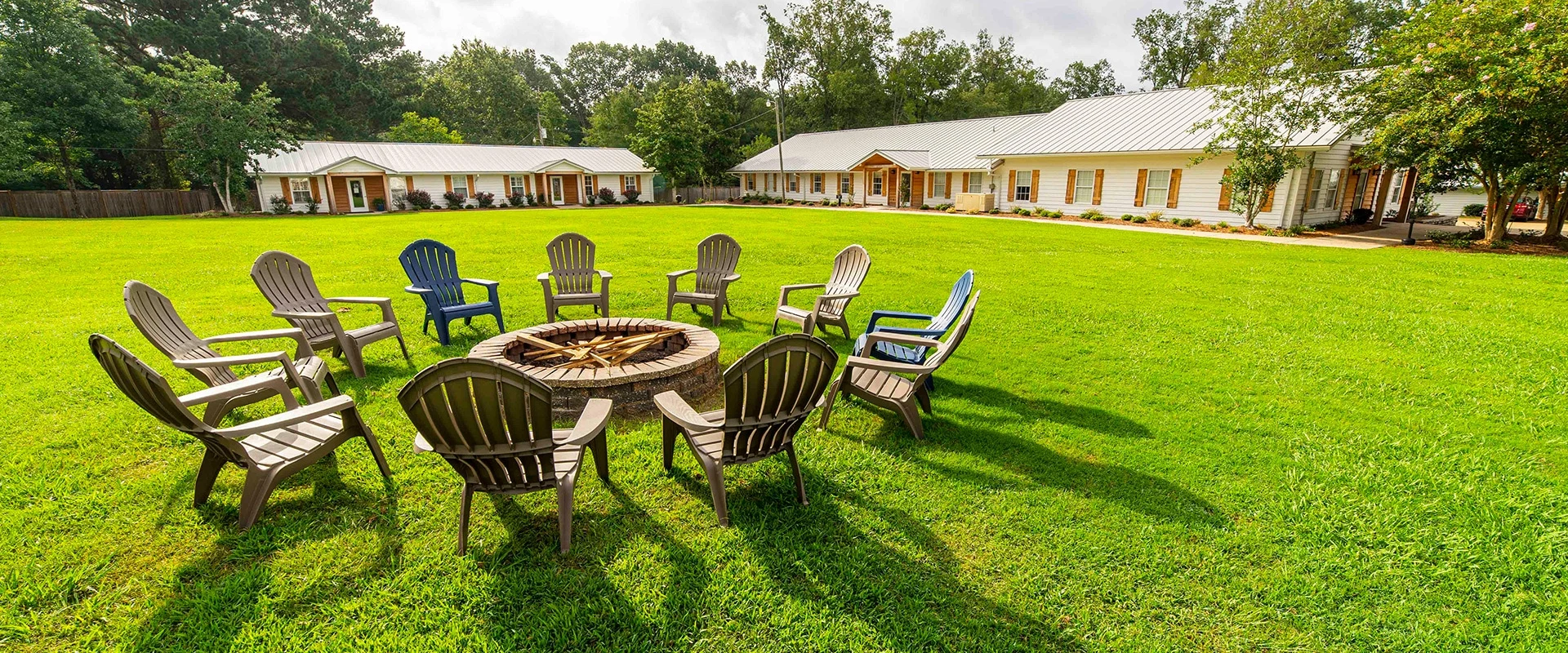Circle of Adirondack chairs on lush lawn
