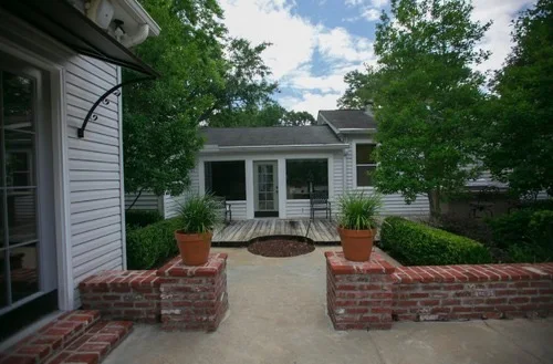 Brick patio with potted plants and outdoor seating