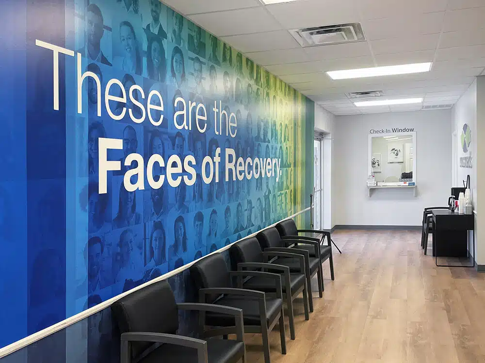 Waiting room with chairs and large Faces of Recovery mural