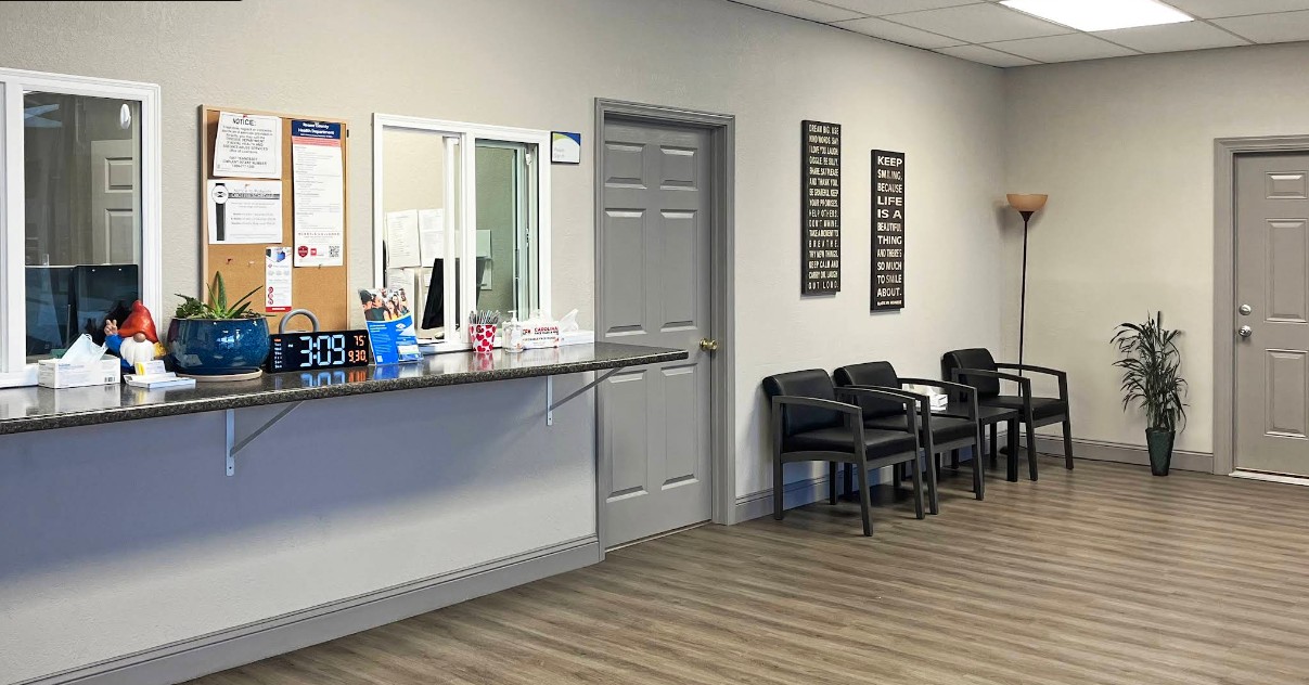 Reception desk and chairs in clinic waiting room
