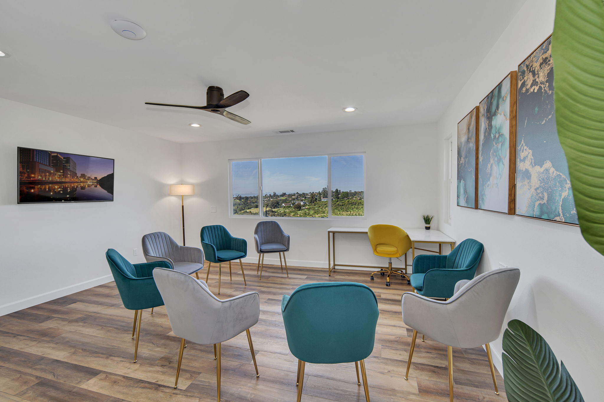 Chairs arranged in circle in sunny meeting room